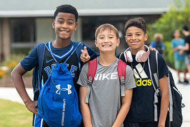 Three students standing outside together. Links to Gifts That Pay You Income Three students standing outside together. Links to Gifts That Pay You Income