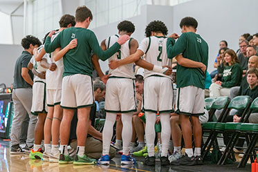 The boys basketball team in a huddle. Links to Closely Held Business Stock The boys basketball team in a huddle. Links to Closely Held Business Stock