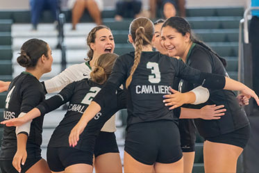 Female students happily gathering in a group hug during a sports event. Links to Gifts by Will Female students happily gathering in a group hug during a sports event. Links to Gifts by Will